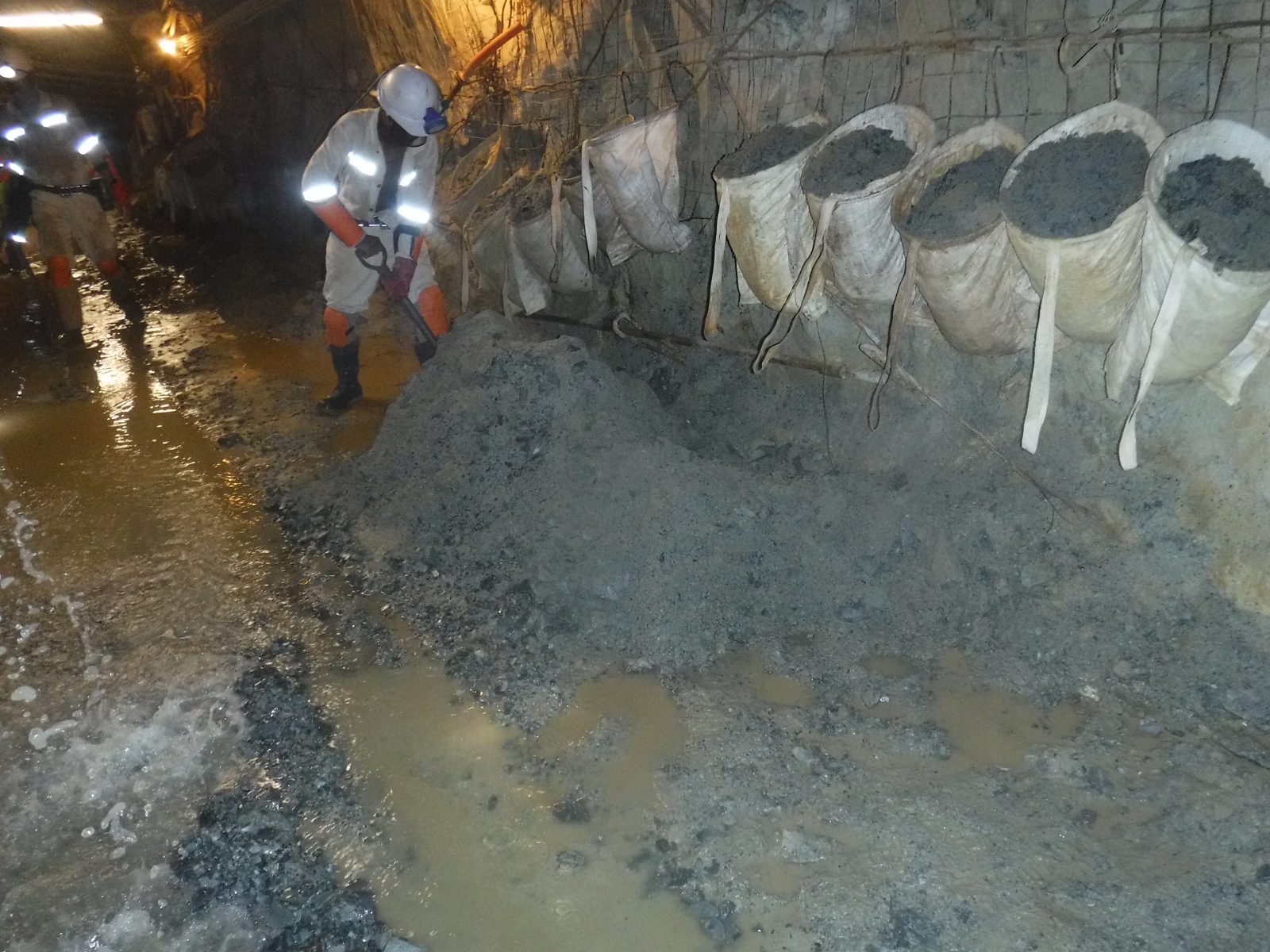 Mud being loaded out of a haulage during cross cut rehabilitation