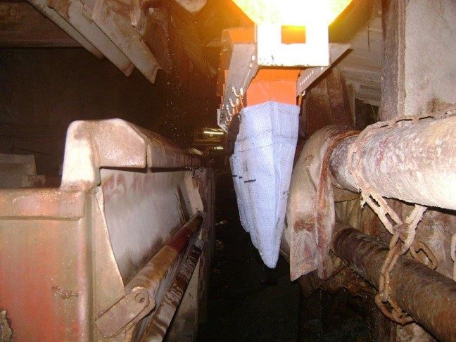 Mud Accumulator collection bag filling with mud alongside the cross-cut pipework