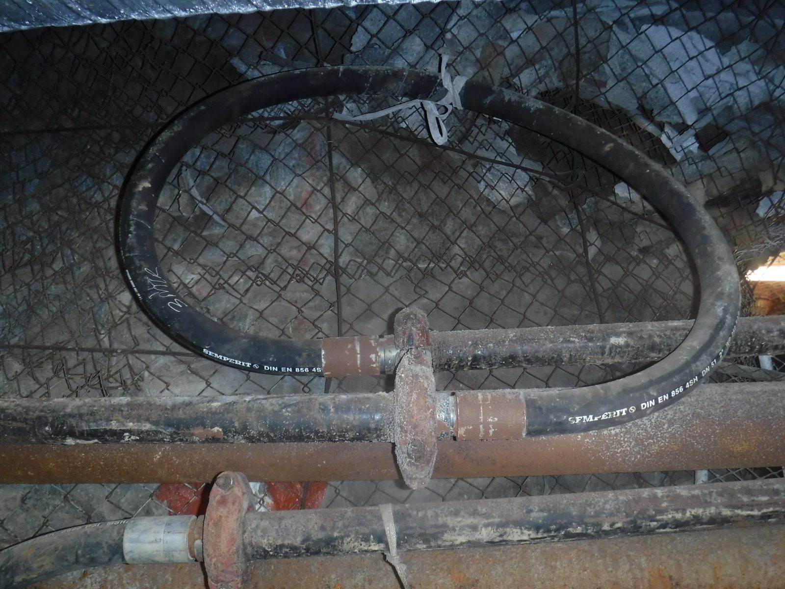 Reticulation line routed to draw flushing water away from the backfill bag