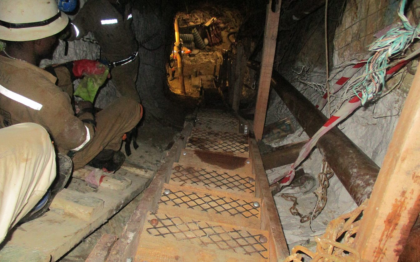 Mineworker descending an Adjustable Stairway in an inclined underground travelling way