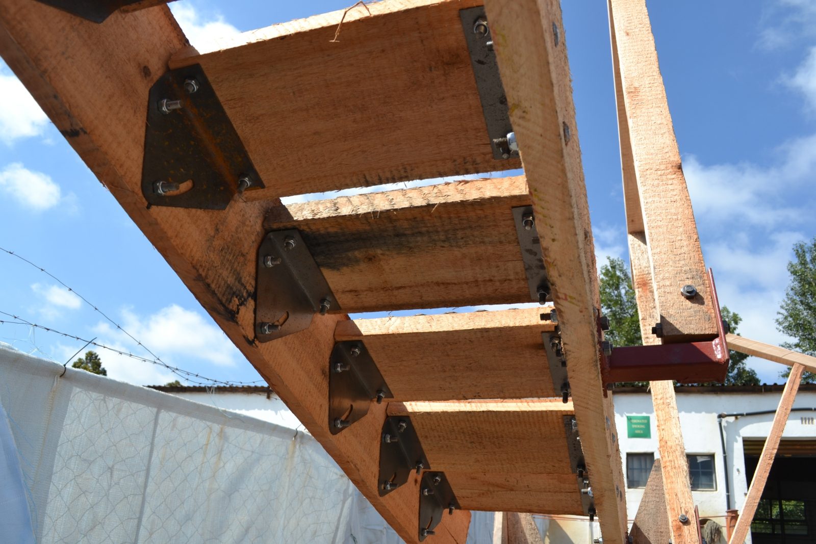 Underside of the Adjustable Stairway showing the steel adjustment brackets that let each tread be re-levelled